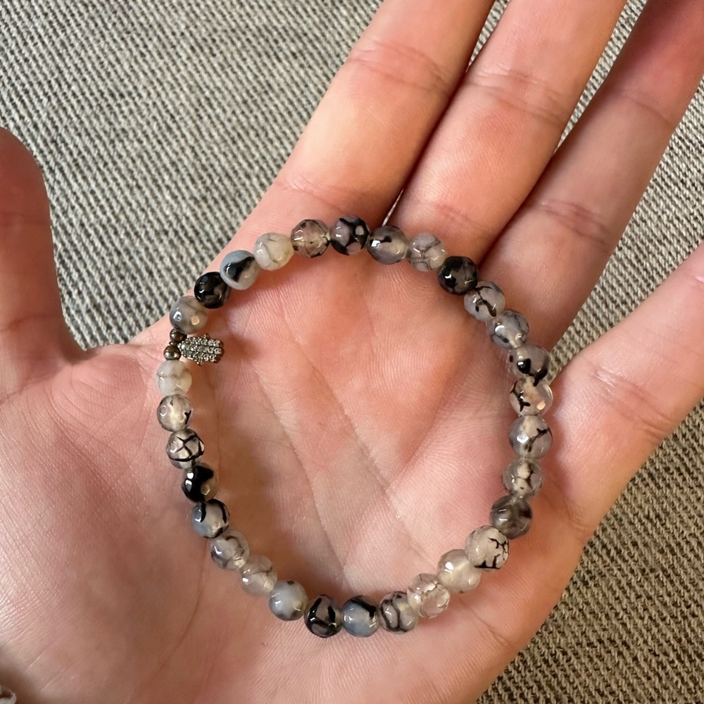 Grey and blue toned beaded bracelet with hamsa hand charm